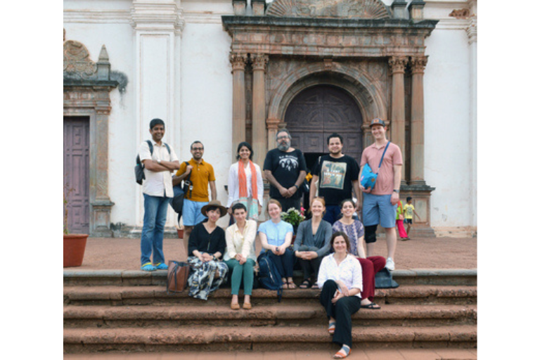 Students posing in front of ancient building